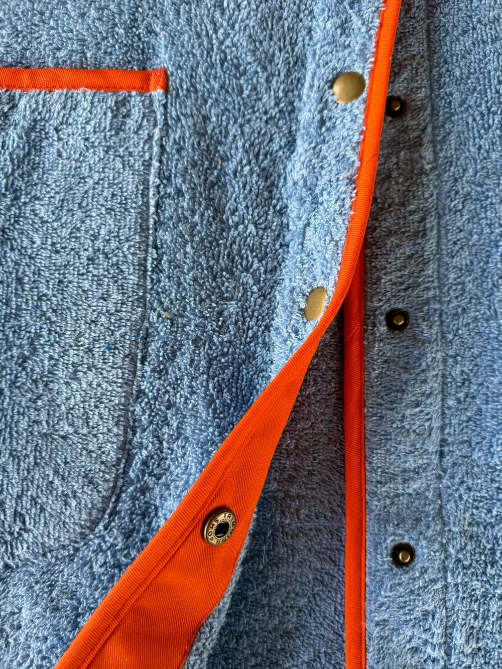 Ramona blue long towelling robe with orange button detail close up