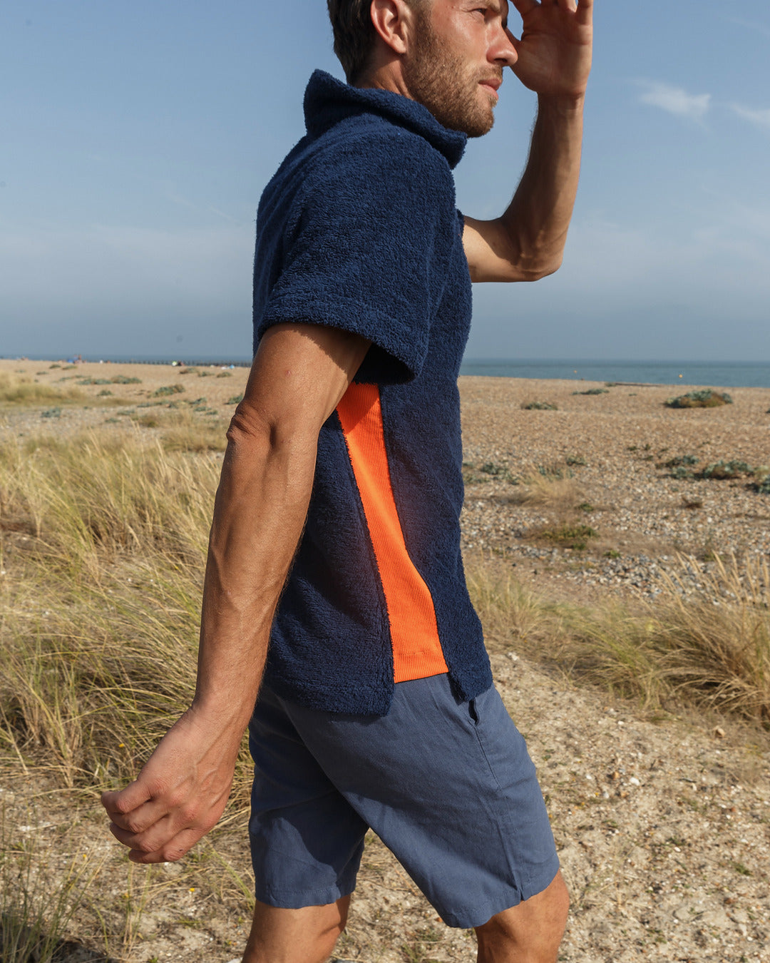 So English navy and orange polo shirt featuring a classic fit, casual style, made in the UK.