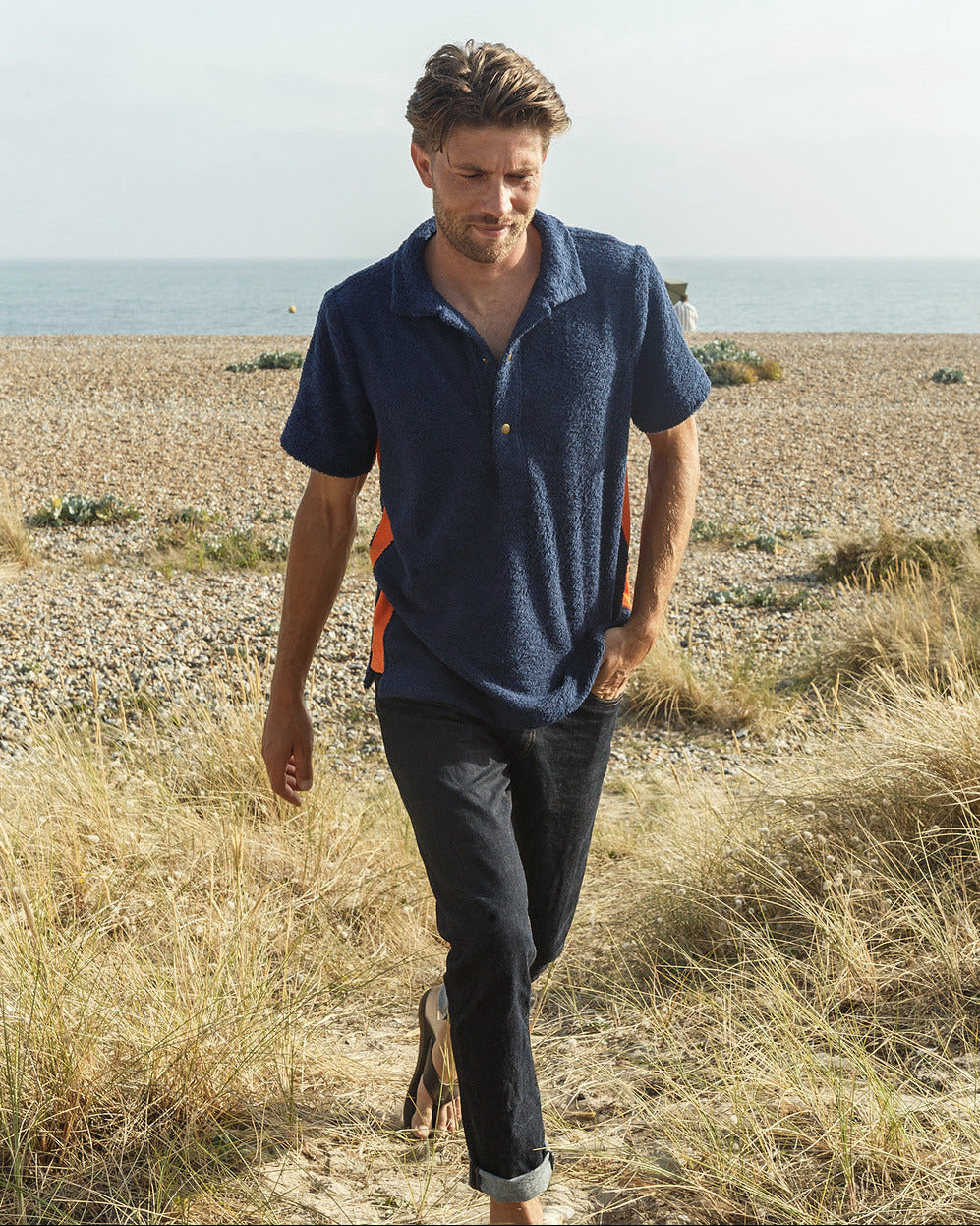 So English navy and orange polo shirt, stylish men's casual shirt with a classic fit and vibrant color block design.