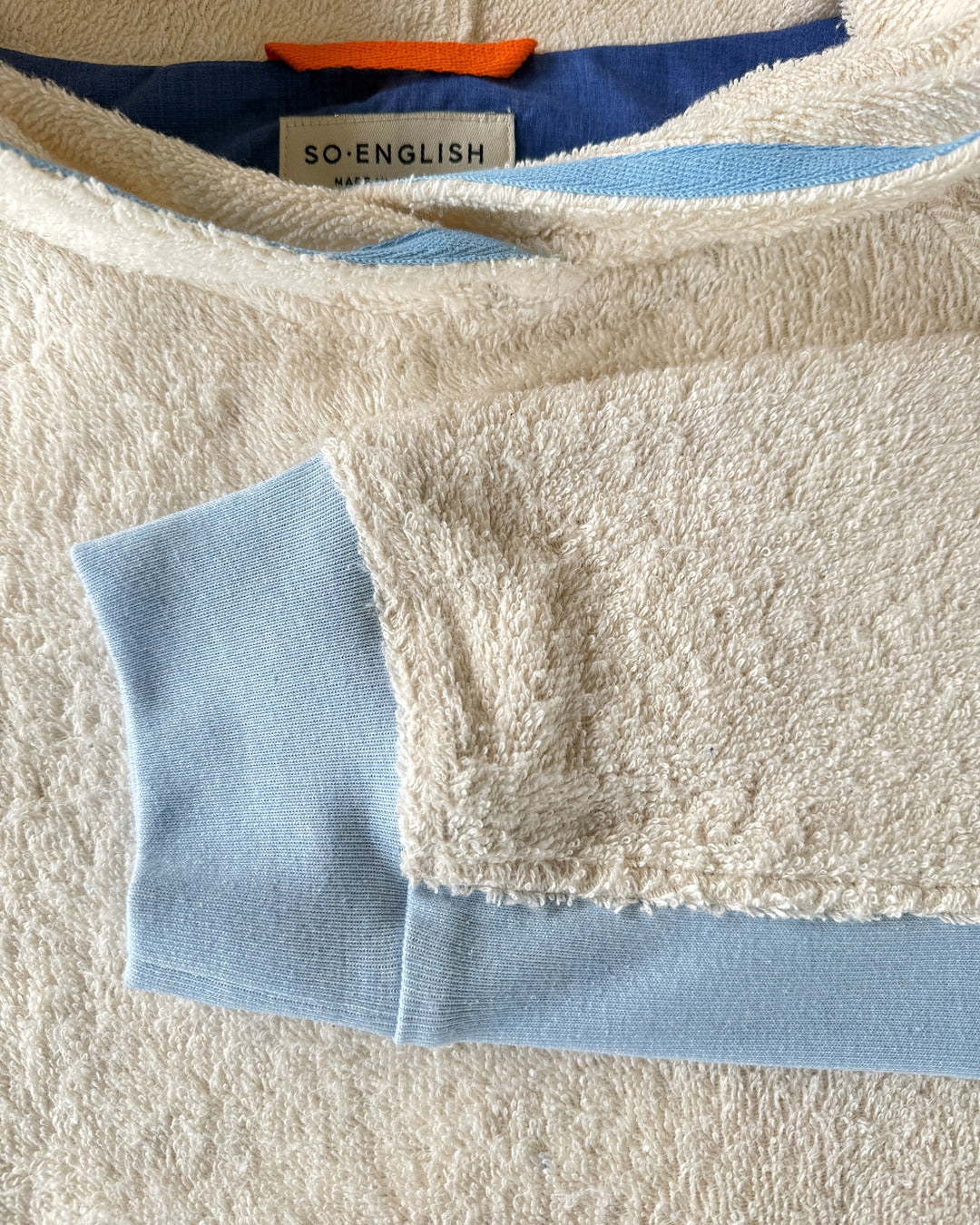 Ecru and sky blue long hoodie by So English featuring a relaxed fit, casual style, and soft fabric, perfect for beachwear.