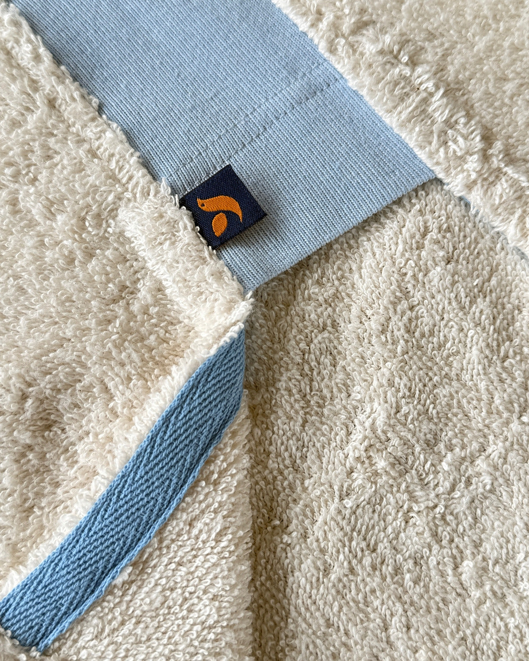 Ecru and sky blue long hoodie by So English, featuring a relaxed fit and soft stretch fabric, perfect for casual beachwear.