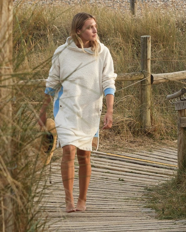 Ecru and sky blue long hoodie by So English featuring a relaxed fit, shown being worn casually outdoors.