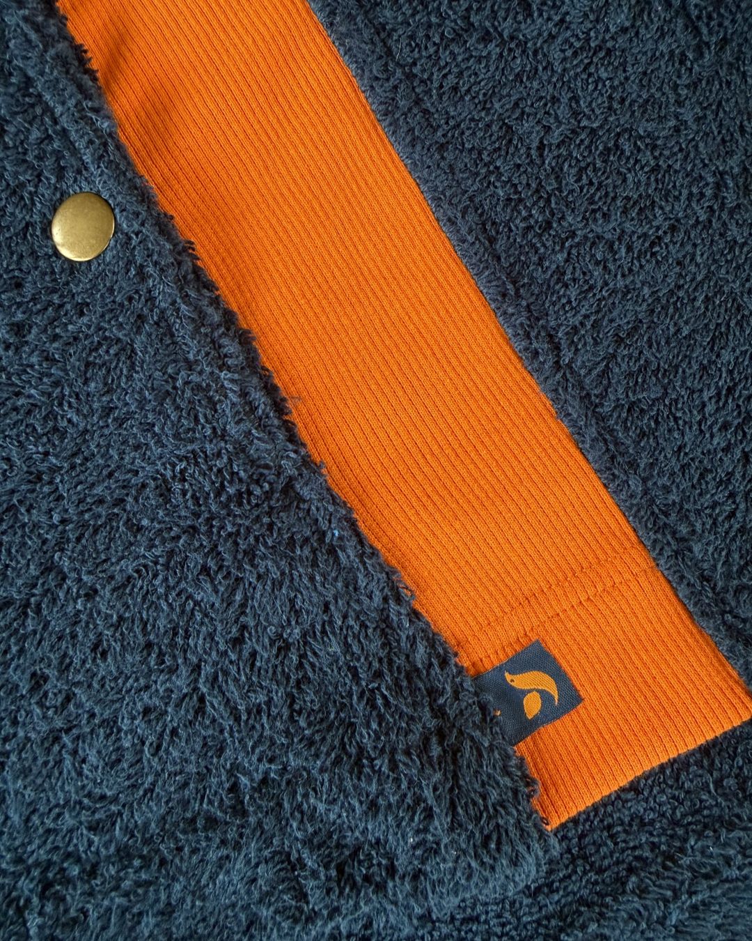 Navy and orange So English Hampstead hoodie with stretch detail, casual style, made in the UK, displayed on a plain background.