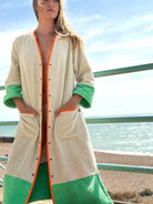 Model wearing Ramona almond + green long towelling robe at the beach