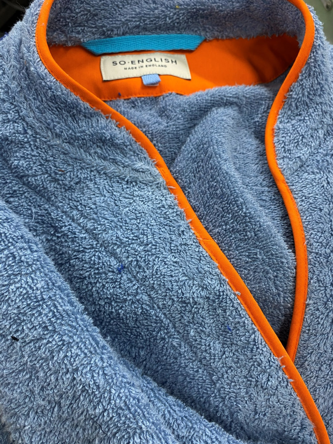 Ramona blue long towelling robe with orange detail neckline close up