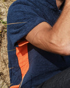 Navy and orange Bond polo shirt by So English, showing close-up of fabric and color details on a casual shirt.