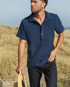 Navy and orange Bond polo shirt by So English, featuring a classic design and breathable fabric, displayed on a plain background.