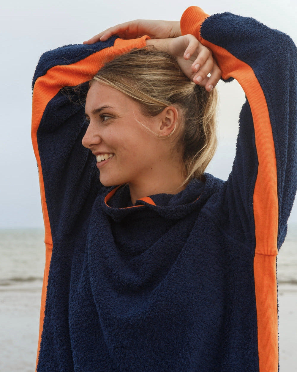 Navy and orange long hoodie from So English with a relaxed fit, displayed on a hanger.