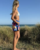 So English Carly print shorts featuring colorful beachwear design, made in the UK, displayed on a model.