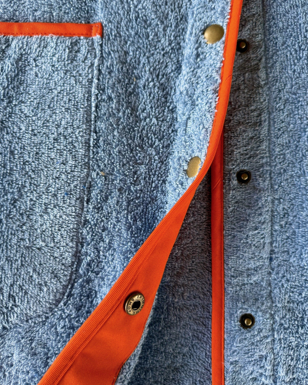 Blue Ramona short robe dress by So English, featuring lightweight fabric and casual beachwear style, photographed with detailed buttons.