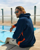 Navy and orange So English Hampstead hoodie displayed in a casual lifestyle setting, highlighting the comfortable hooded sweatshirt.