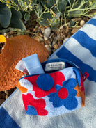 So English beachwear pochette bag with stylish design, made in the UK, featuring a compact and fashionable accessory for summer outings.