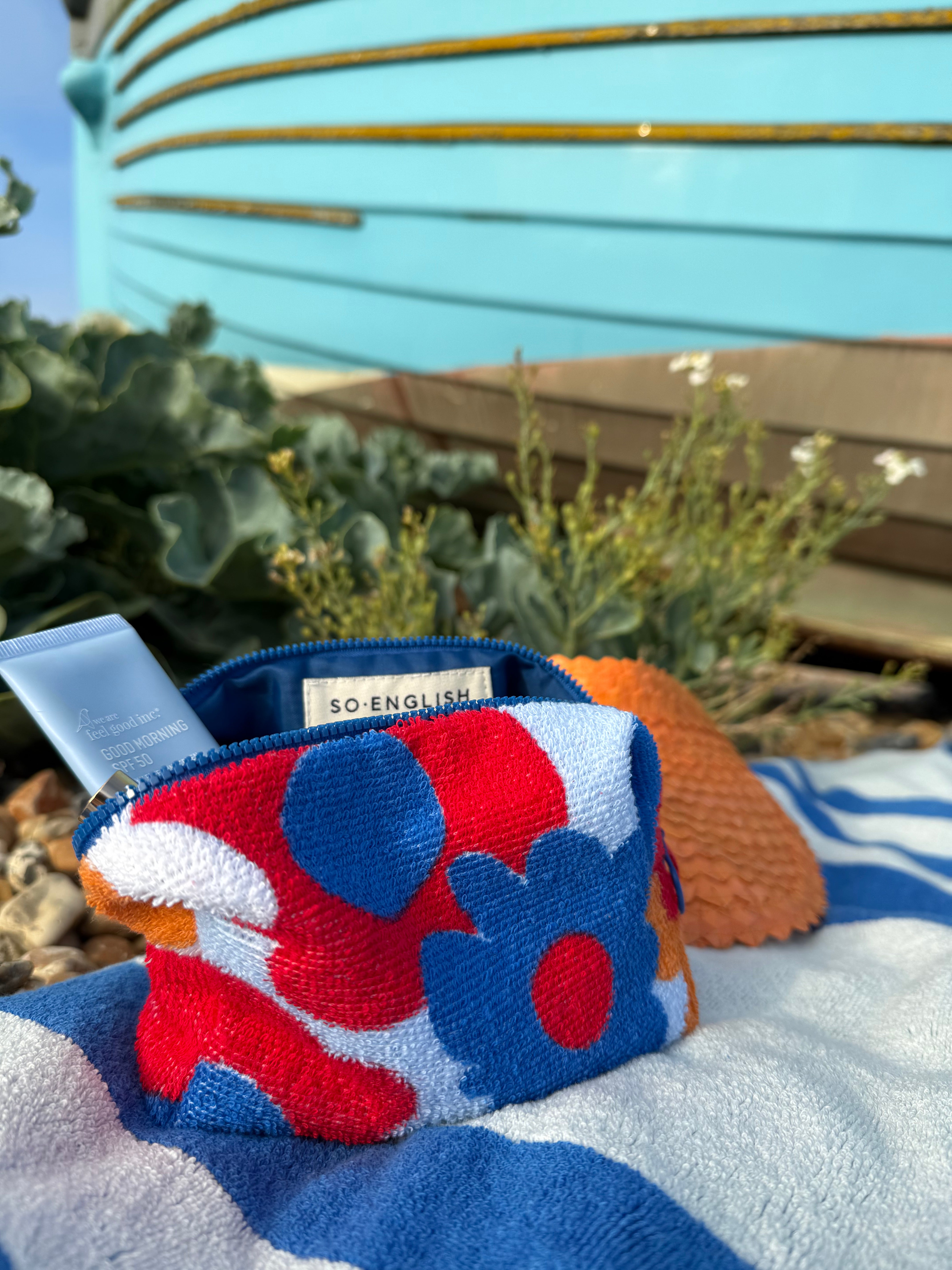 So English beachwear pochette bag, stylish small bag made in the UK, featuring a sleek design, perfect for casual summer outings.