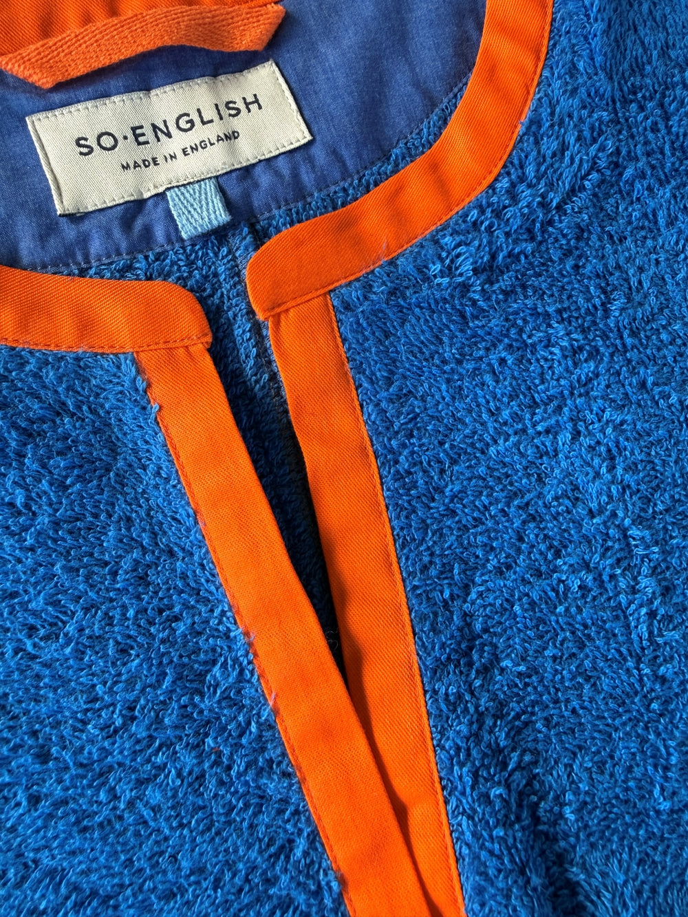 So English Kiss Brighton Blue short dress with neck detail, made in the UK, featuring a stylish blue beachwear design.
