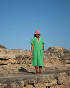 Long green dress by So English featuring a fresh, vibrant design, perfect for beachwear or casual summer outings.