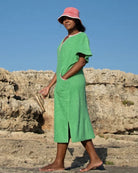 Long fresh green Kiss dress by So English, stylish beachwear with a flowing design and vibrant color, perfect for summer days.