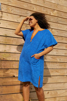 So English Brighton Blue Kiss dress, short beachwear style, lightweight fabric, casual summer dress, outdoor setting.