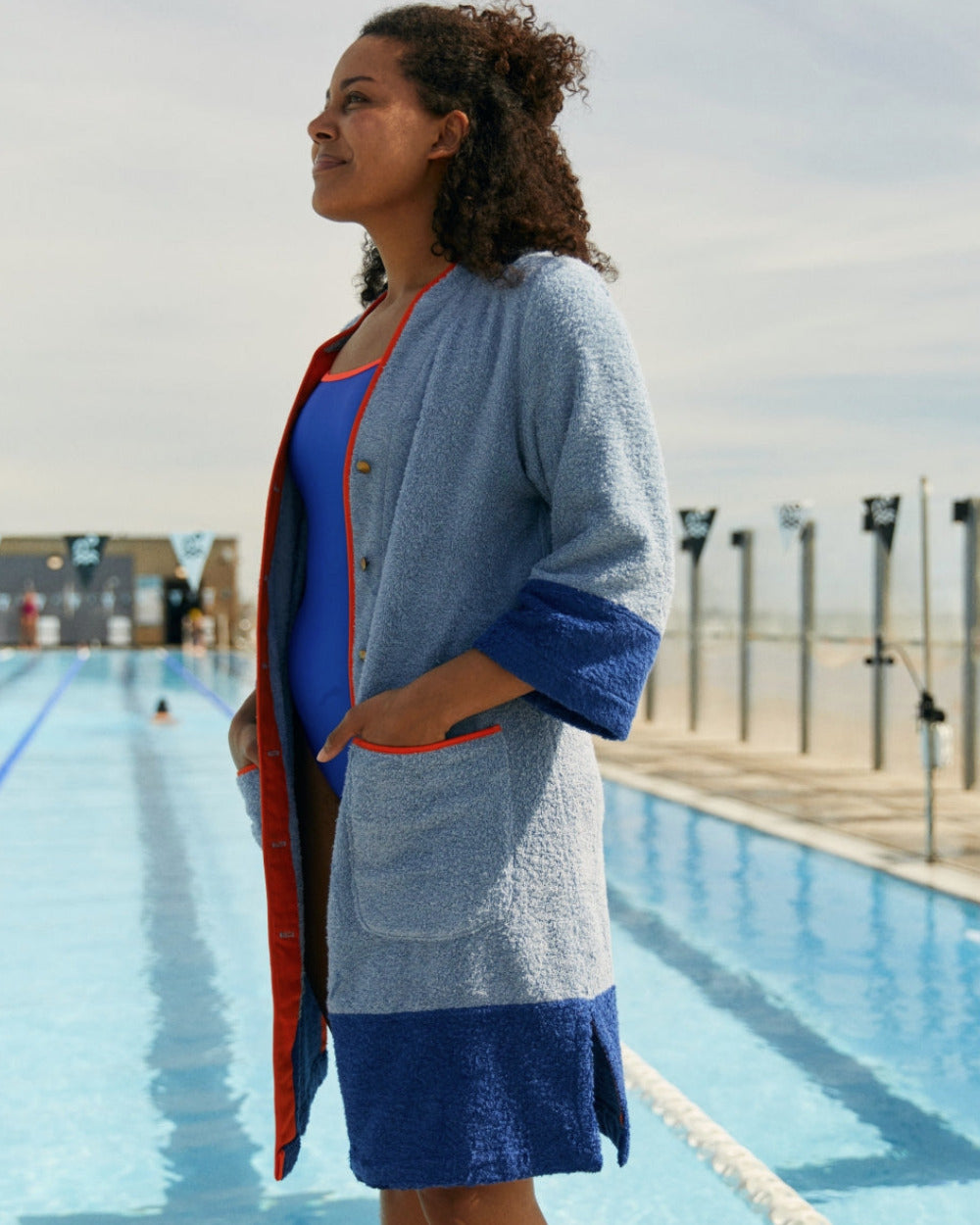 Blue Ramona short robe dress by So English, featuring a casual beachwear style and made in the UK, displayed on a stand.