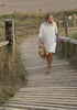 Video of a woman wearing the Bude terry towelling long hoodie in Ecru and Sky Blue by So English — Italian cotton, handmade in the UK.